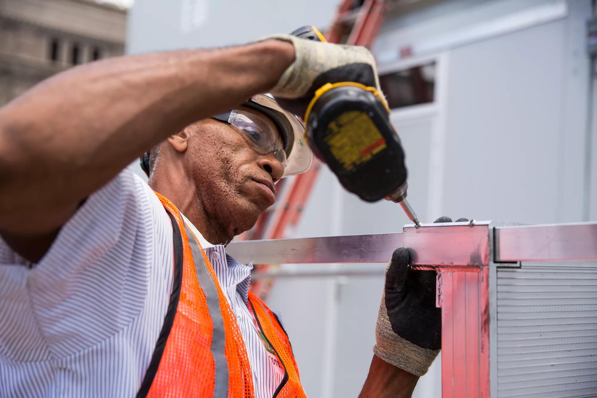 Service worker performing maintenance on modular building